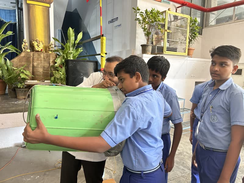 Young students aiming a green air cannon