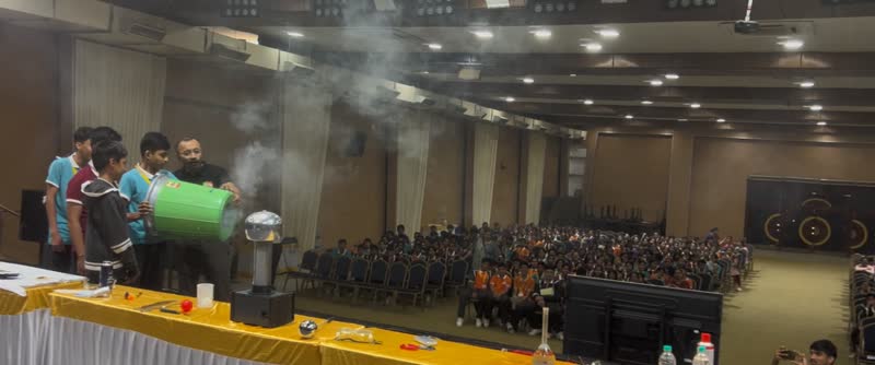 Students firing a smoke-filled air vortex cannon across an auditorium