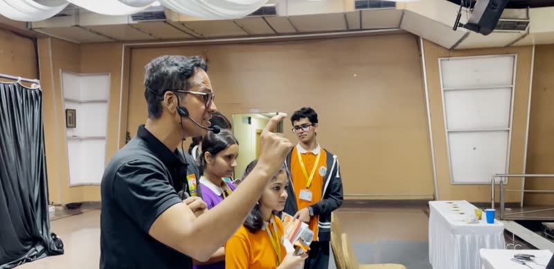 Presenter explains an experiment to a small group of students