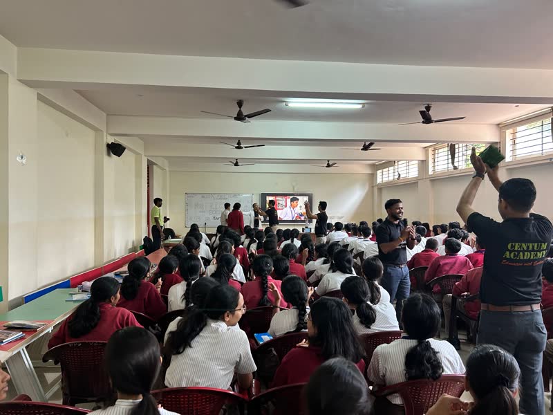 Students watching an experiment in a school hall