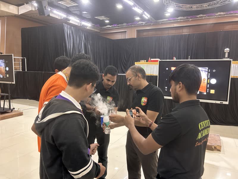 Students handling a liquid nitrogen experiment with presenters